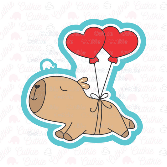 Capibara con globos de corazón